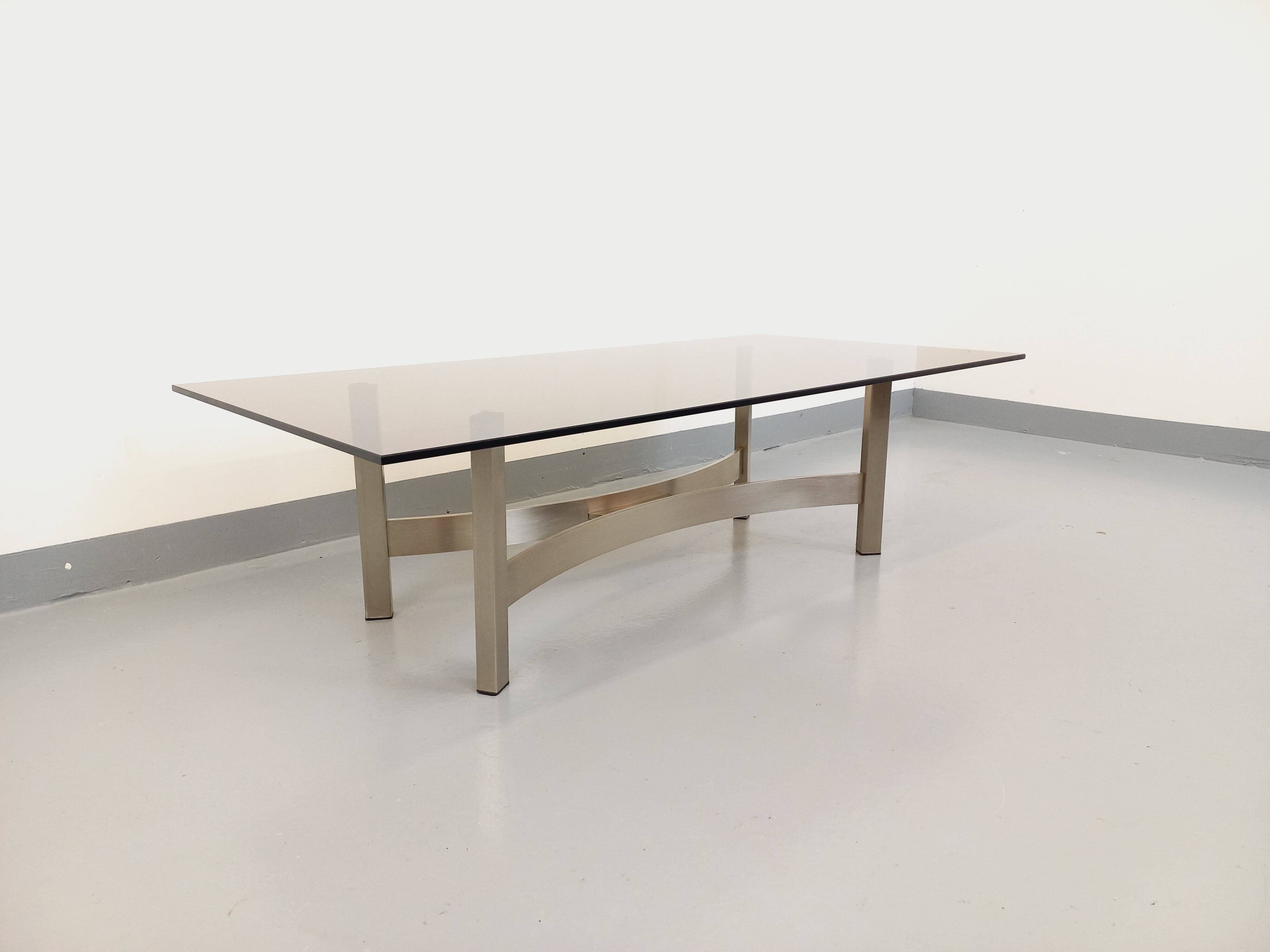 Vintage coffee table in smoked glass and brushed cast aluminum from the 70s