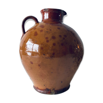 Old pitcher in glazed terracotta