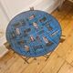 Vintage tripod metal side table with a blue brass bowl.