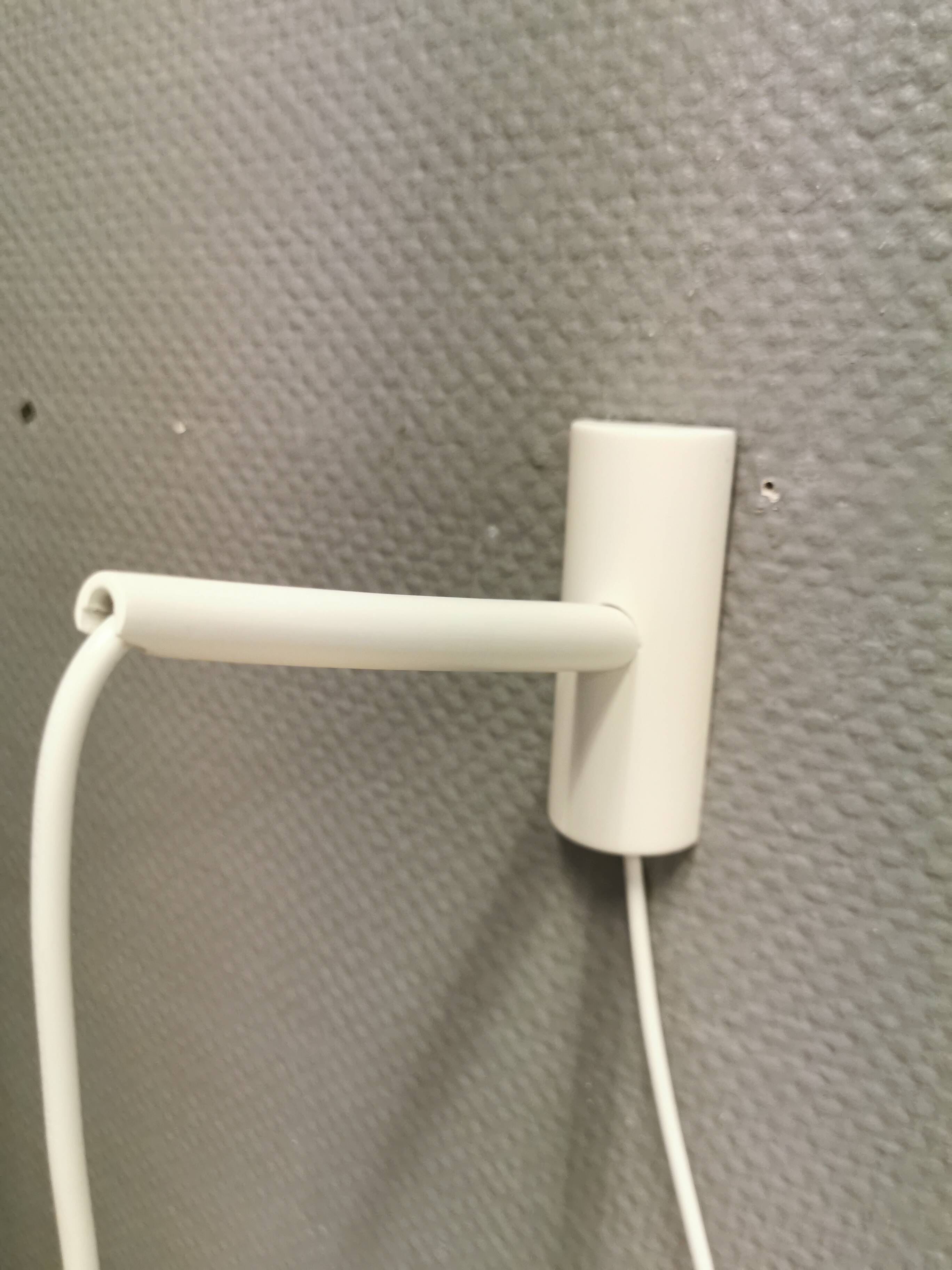 Milky white Holmegaard wall lamp with glass shade and a brass detail on top. Wooden wall bracket