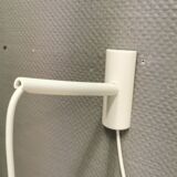 Milky white Holmegaard wall lamp with glass shade and a brass detail on top. Wooden wall bracket