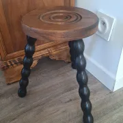 Brown and black wooden tripod stool