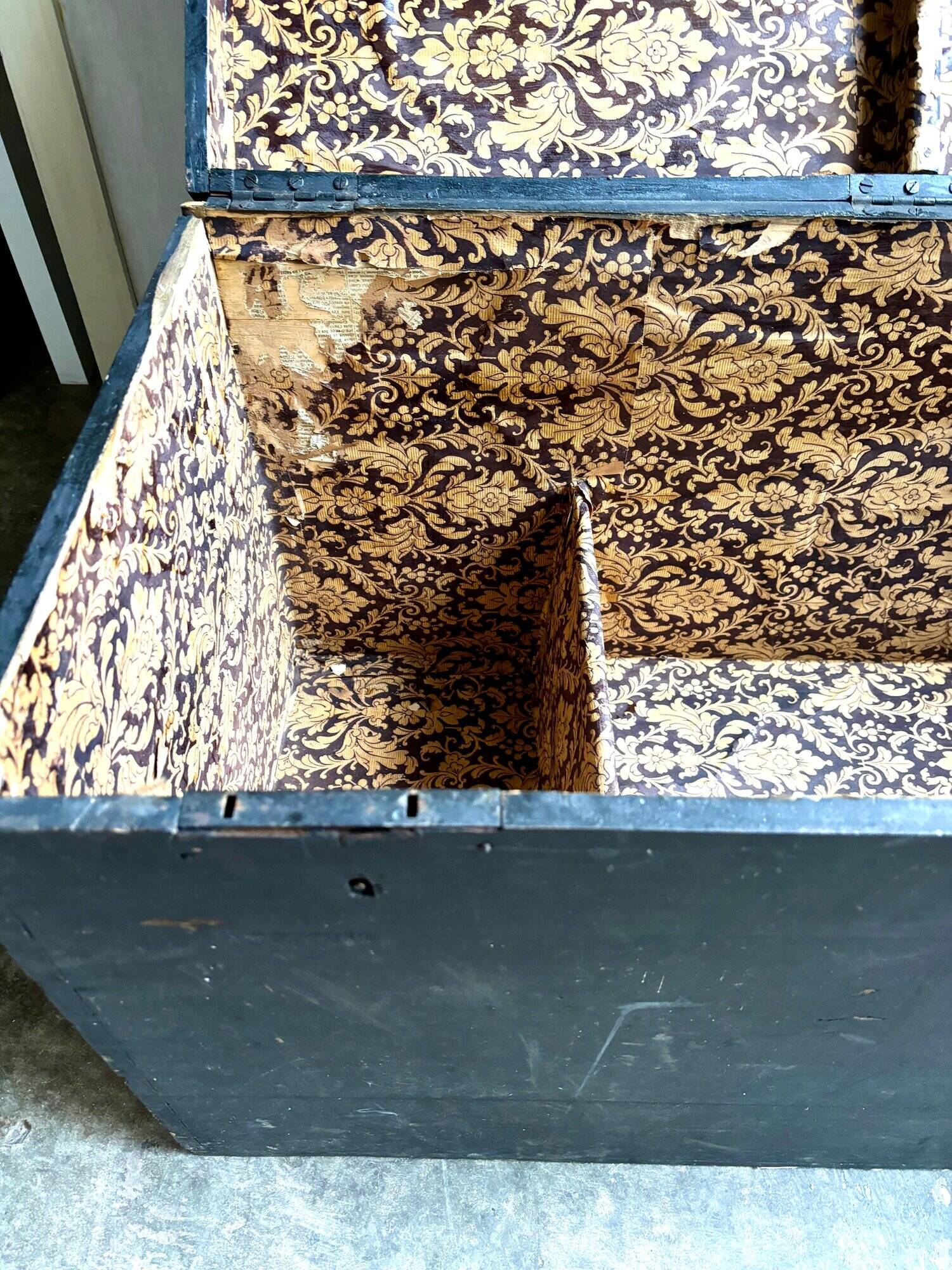 Trunk, black wooden chest and wallpaper