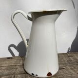 Old white enamelled metal pitcher
