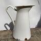 Old white enamelled metal pitcher
