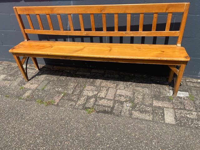Old wooden long station bench from Belgium