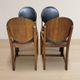 Set of four vintage wooden dining chairs with black leather upholstery