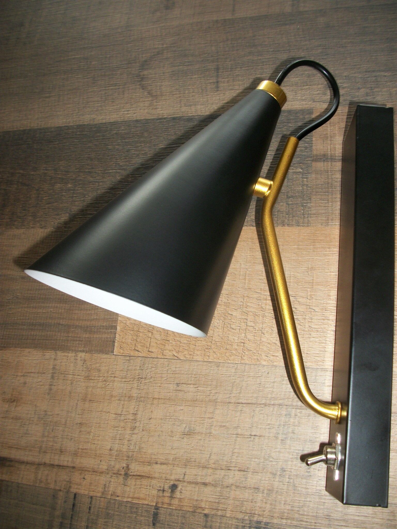 Pair of modernist sconces in black and gold metal
