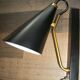 Pair of modernist sconces in black and gold metal