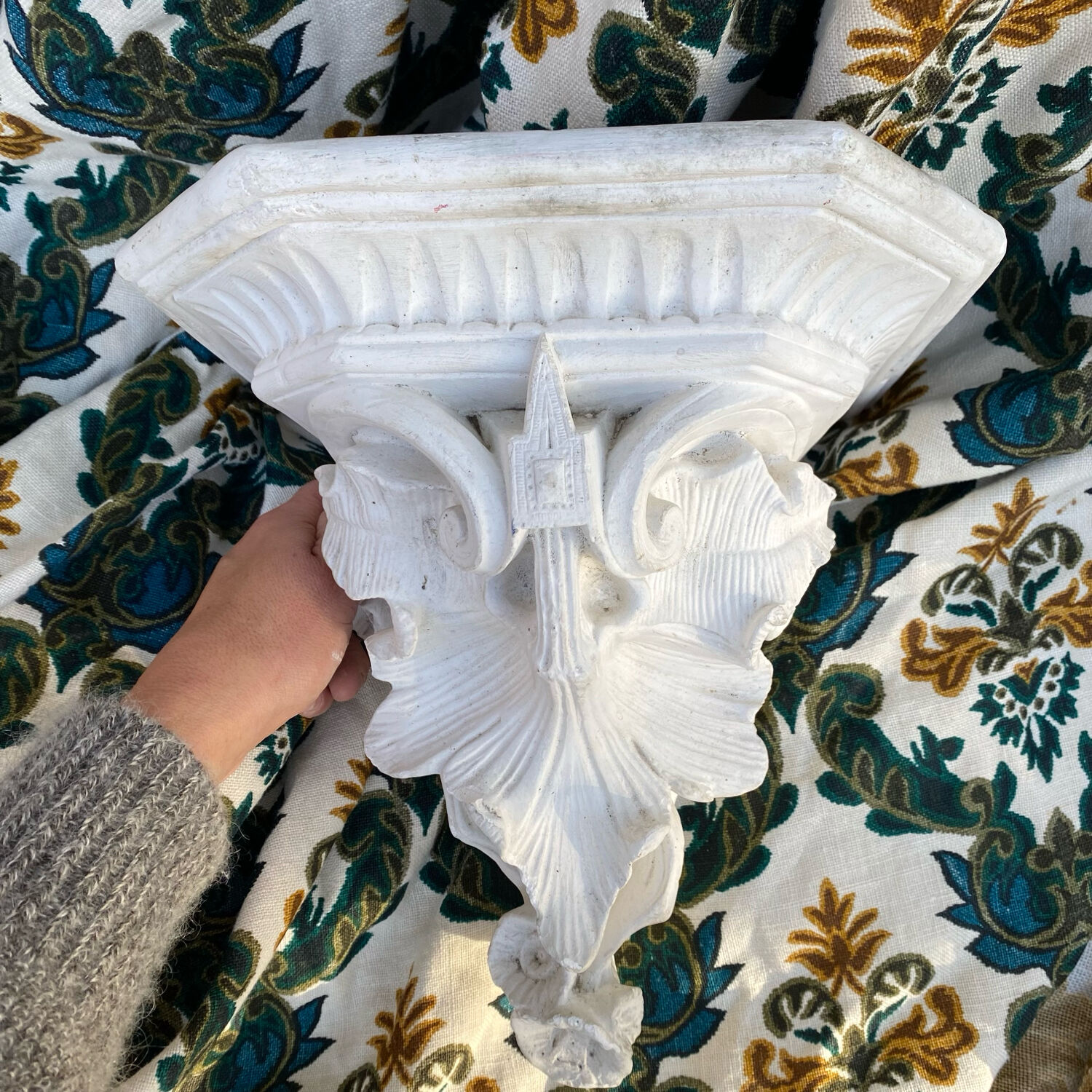 Antique wall console in patinated white plaster.