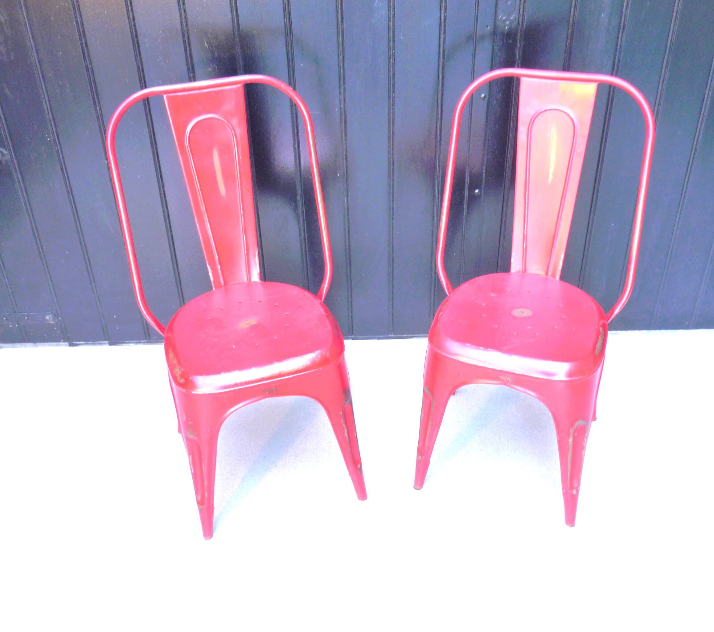 Pair of red stackable metal chairs