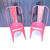 Pair of red stackable metal chairs