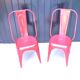 Pair of red stackable metal chairs