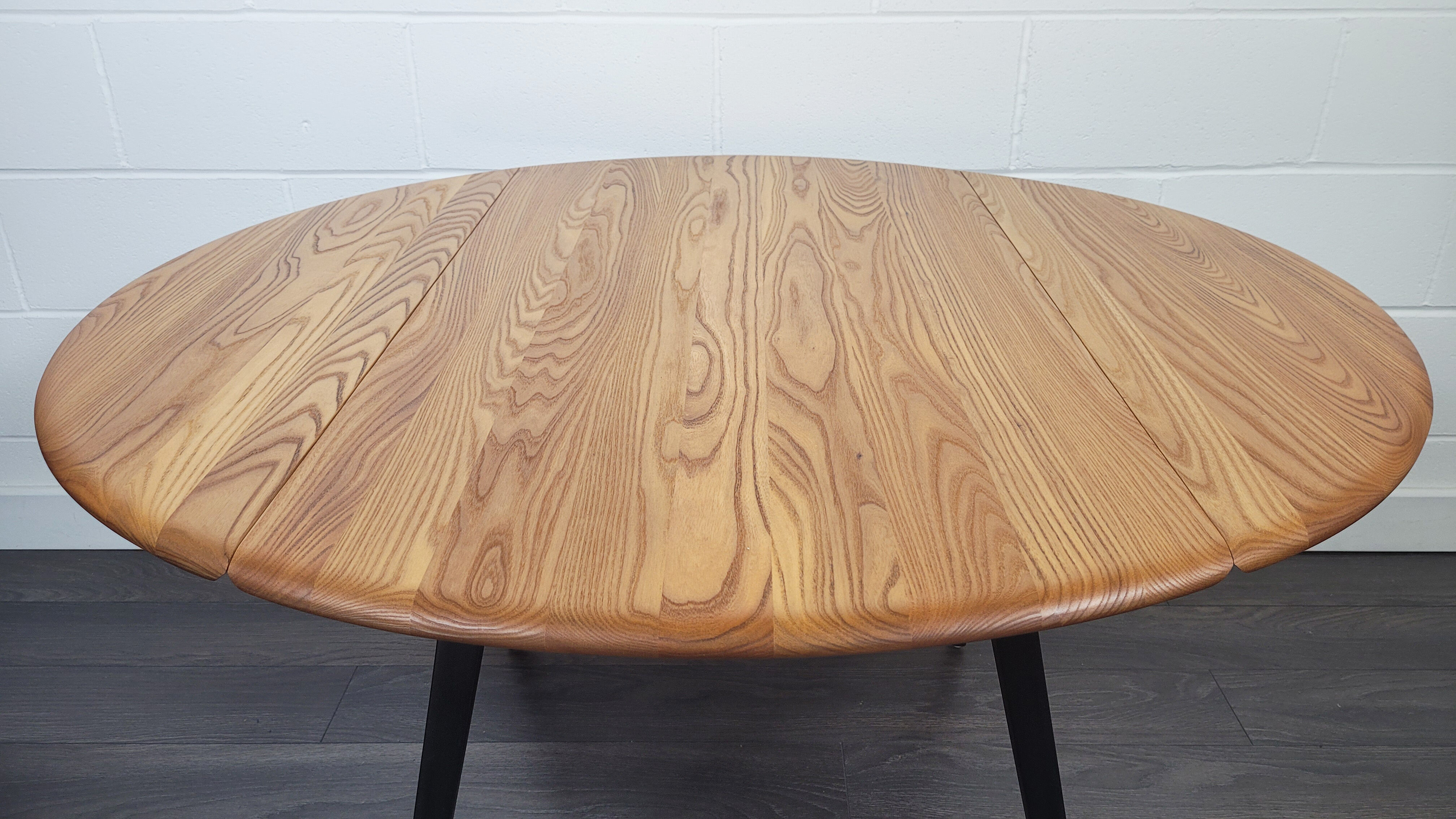 Ercol round drop leaf dining table - black leg, 1960