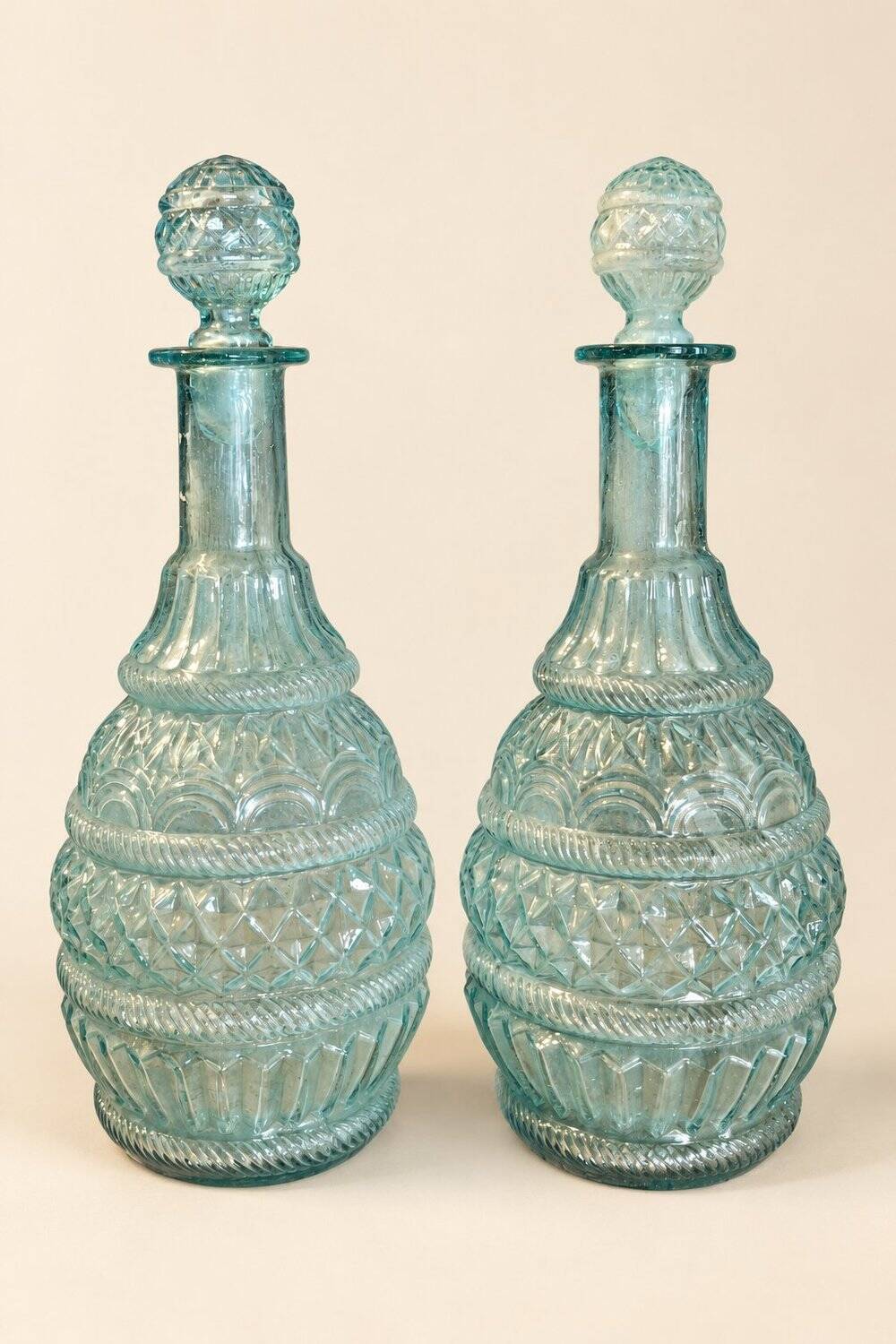 Pair of cut blown glass carafes in blue-green from the 19th century.