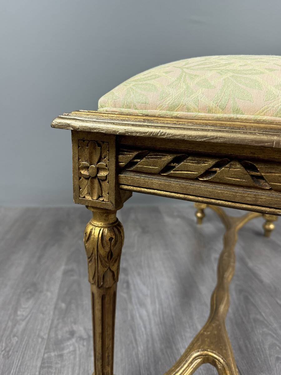 Antique gilded wooden bench in Louis XVI style, 19th century.