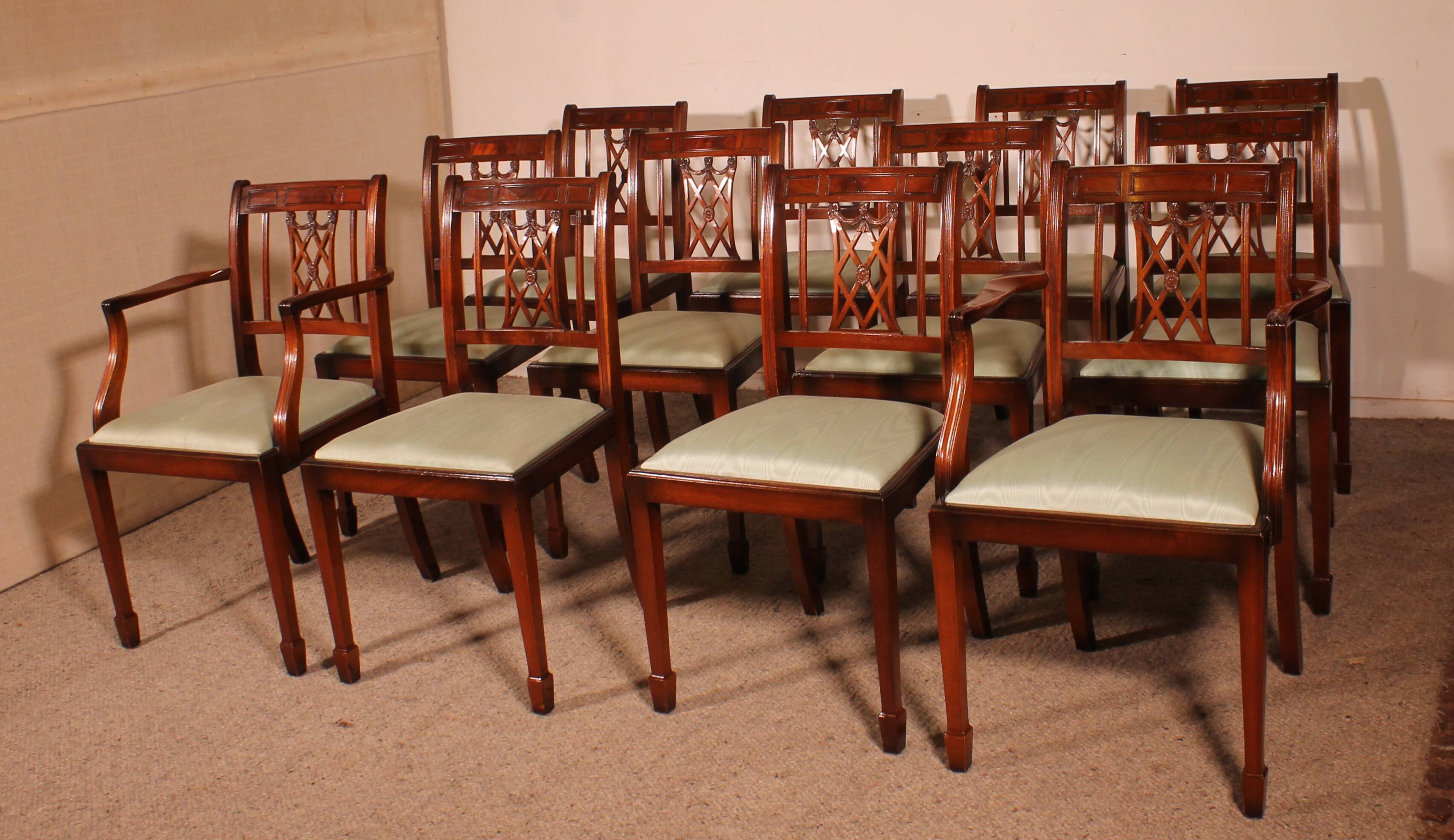 set of 10 chairs and two mahogany armchairs in Hepplewhite style