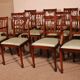 set of 10 chairs and two mahogany armchairs in Hepplewhite style