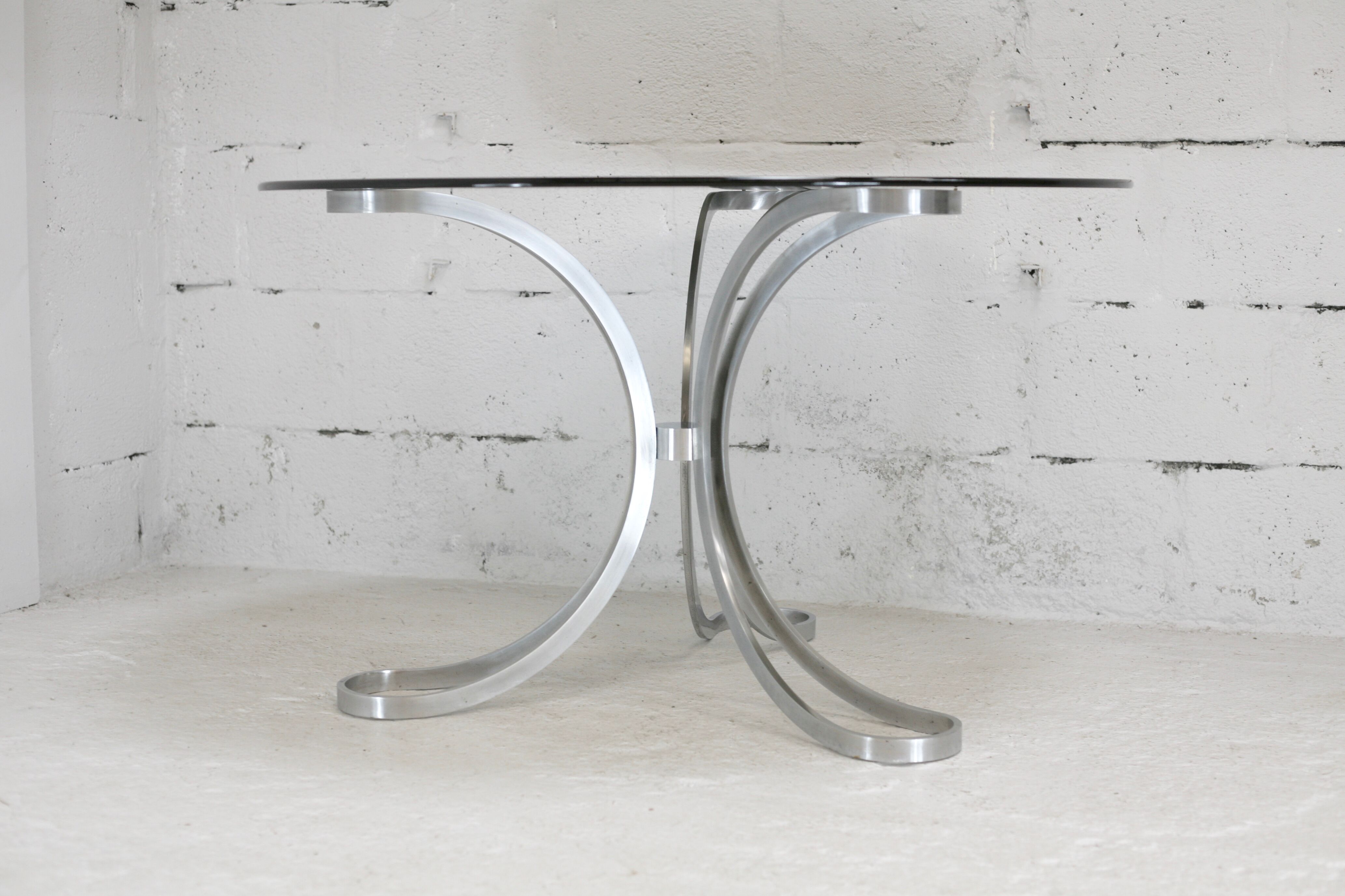 Living room table "Space Age" polished steel, circular slab smoked glass. France, circa 1970.