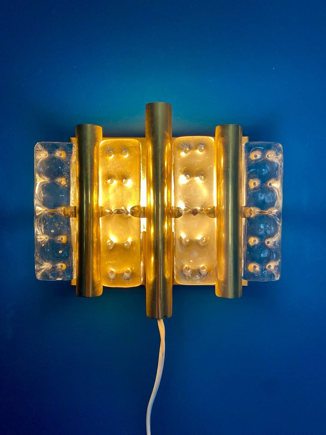 HANS AGNE JAKOBSSON. A pair of glass and brass wall lights