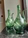 Pair of blown glass wine decanters in blue/green hues.