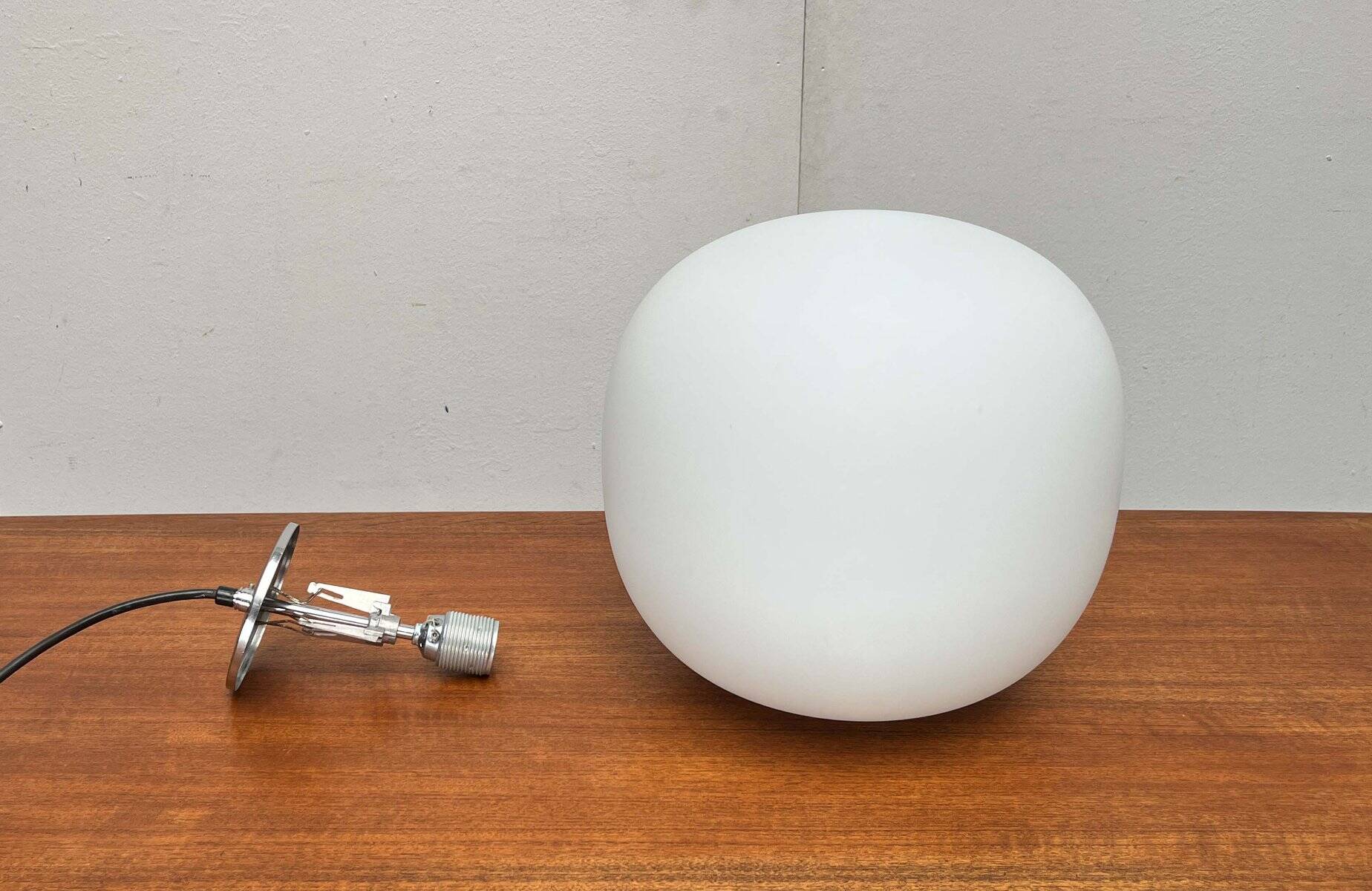 Minimalist suspended glass ball lamp from the vintage German space age by Glashütte Limburg, 1970s.