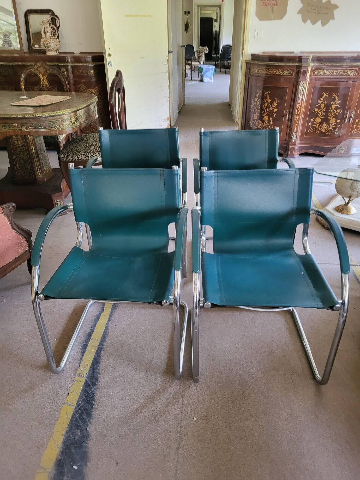 4 vintage Italian armchairs in green leather and chrome metal.