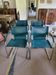 4 vintage Italian armchairs in green leather and chrome metal.