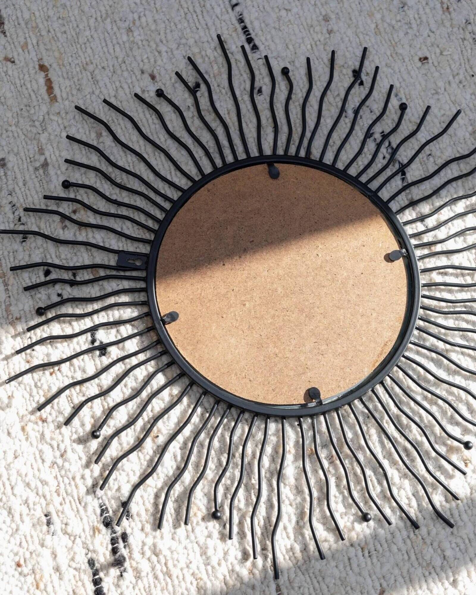 Black metal sunburst wall mirror, round 63x63 cm, vintage 1990s, made in Italy