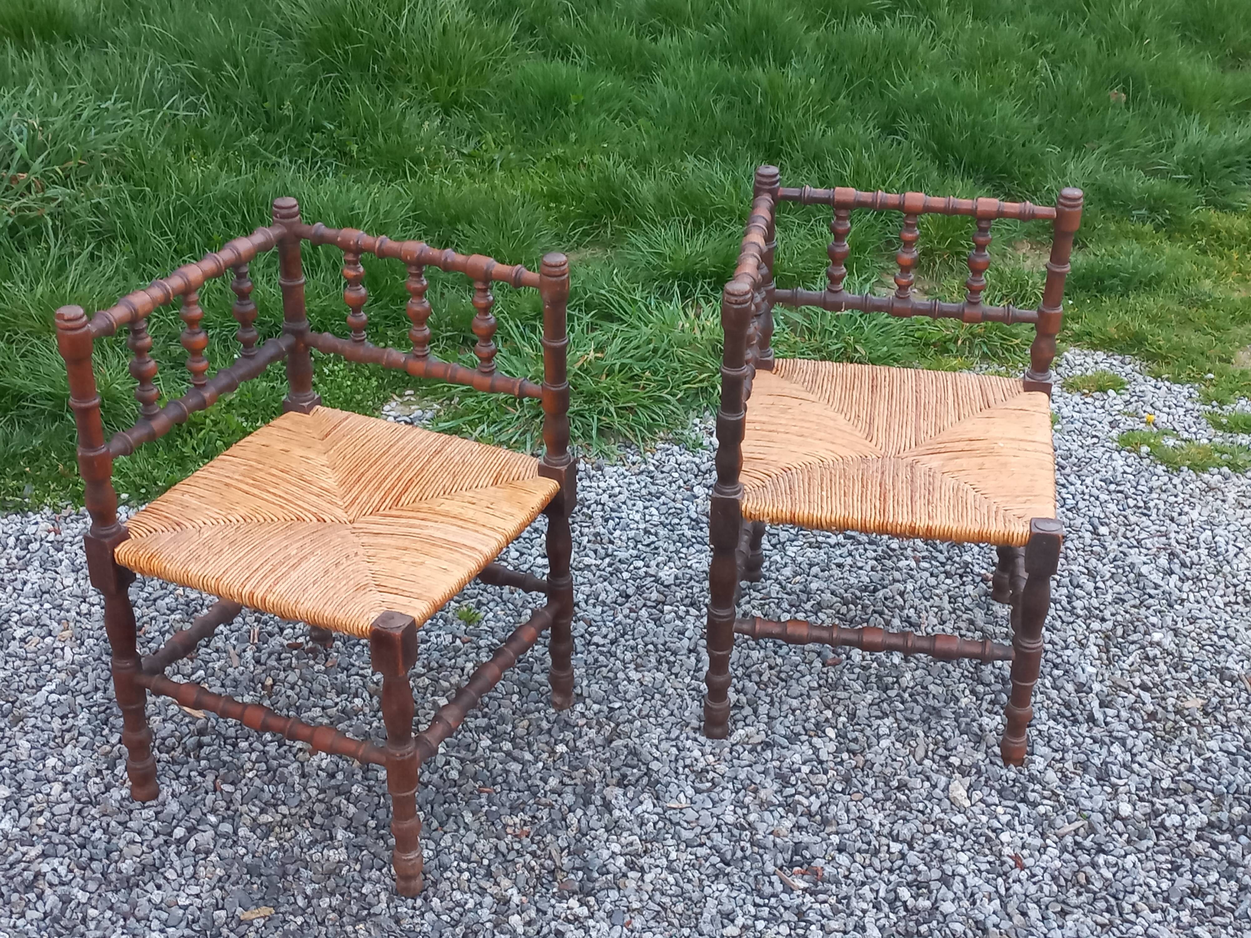 Pair of angled armchairs with turned wood and rush seats from the 1960s.