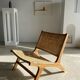 Reclining armchair in natural wood and woven rattan