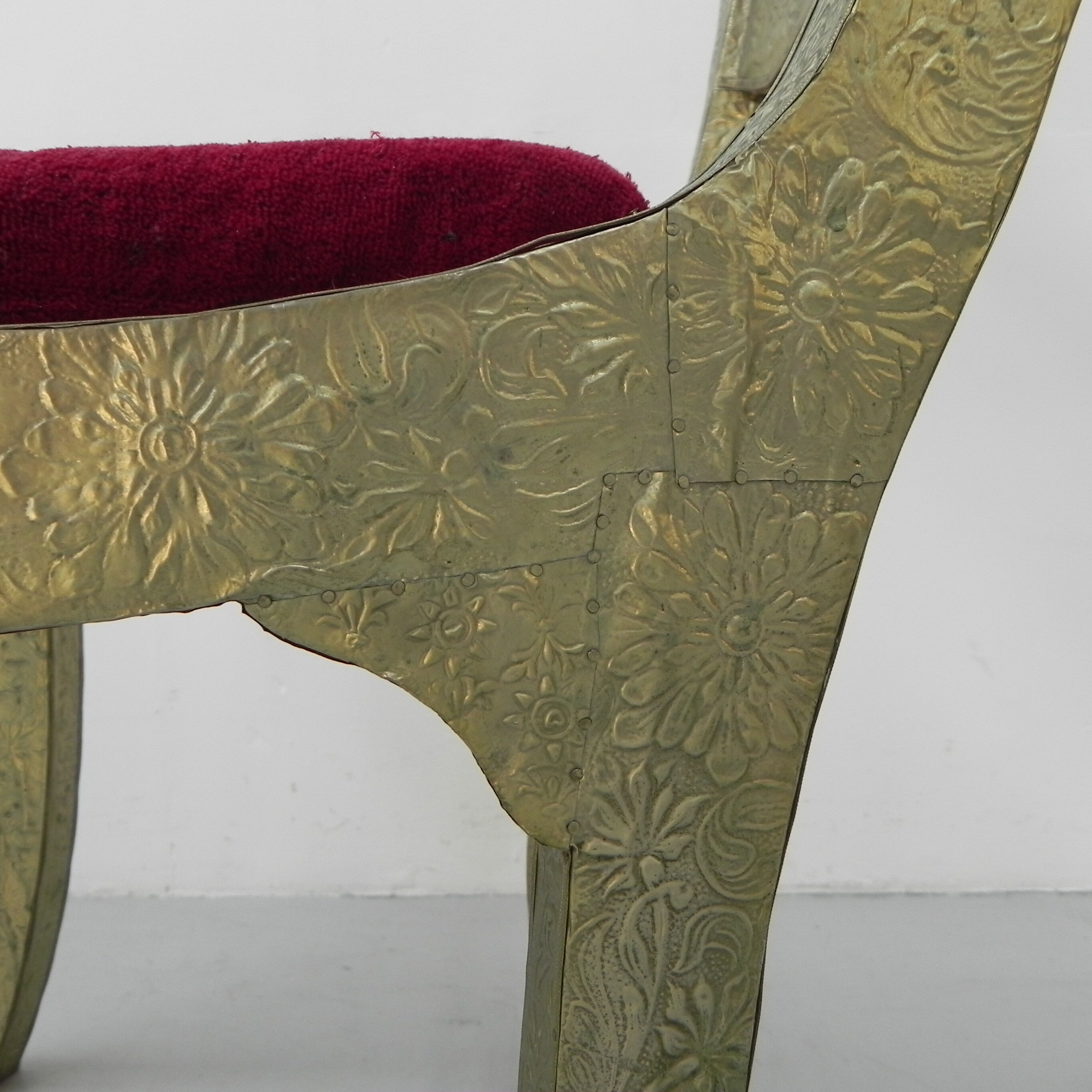 Dining chair upholstered with stamped tin