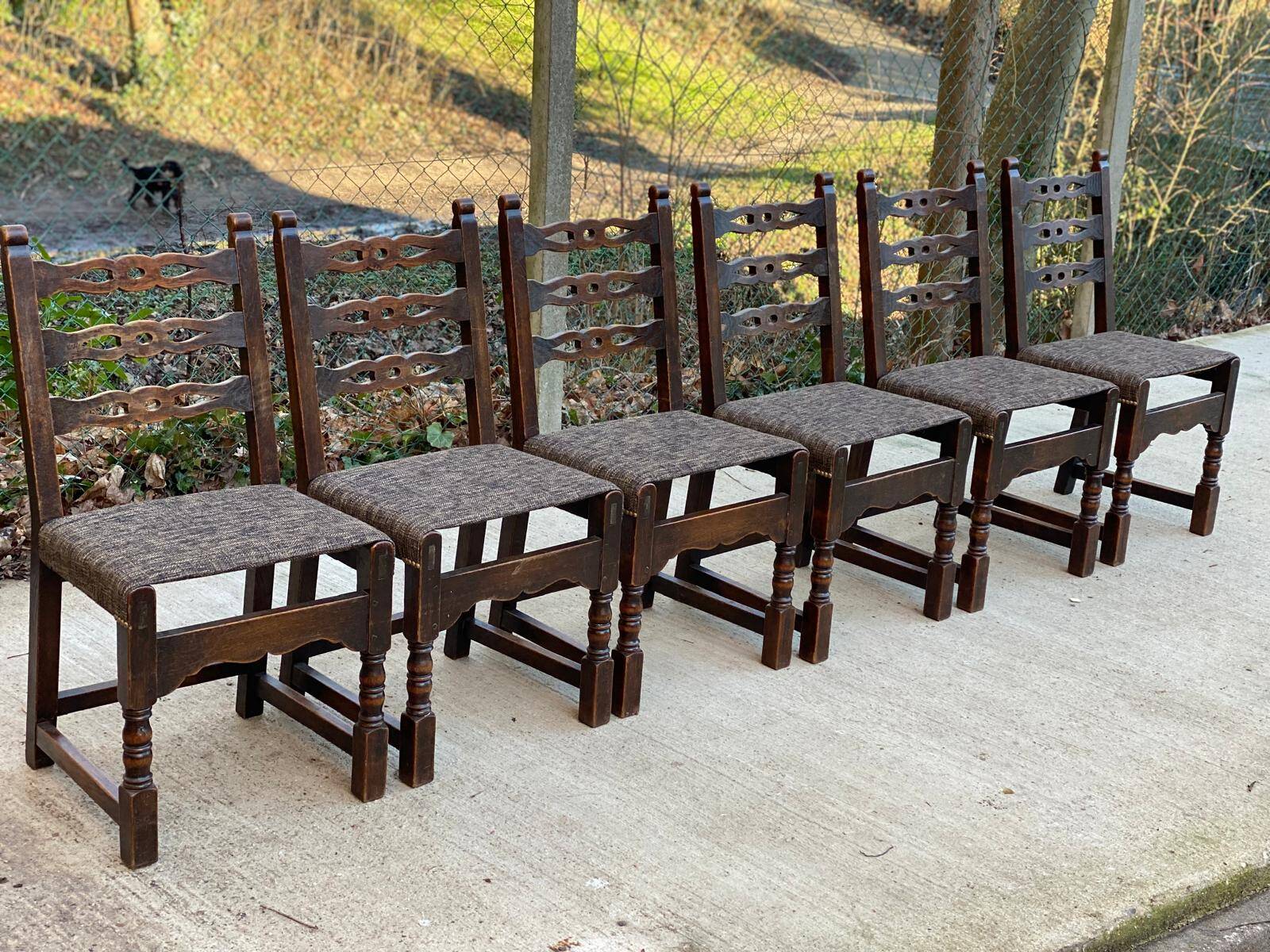 6 solid wood dining chairs with grey woven wool seats.