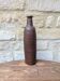 Old handmade terracotta bottle