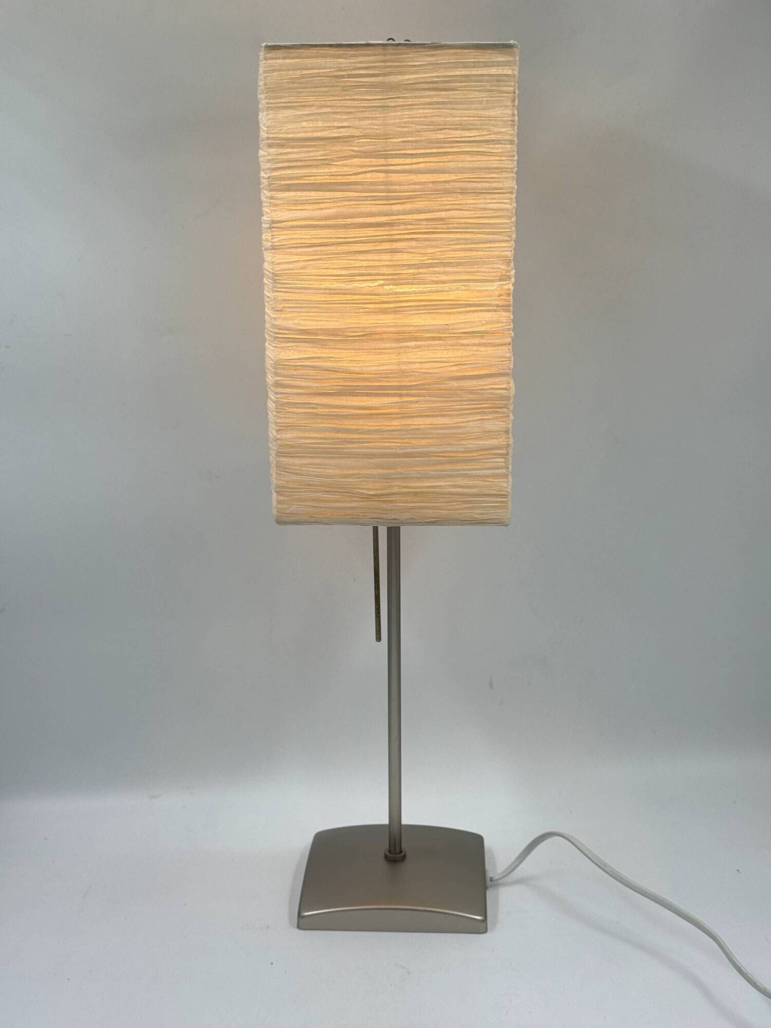 Vintage table lamp made of crumpled rice paper, with a matte metal base.