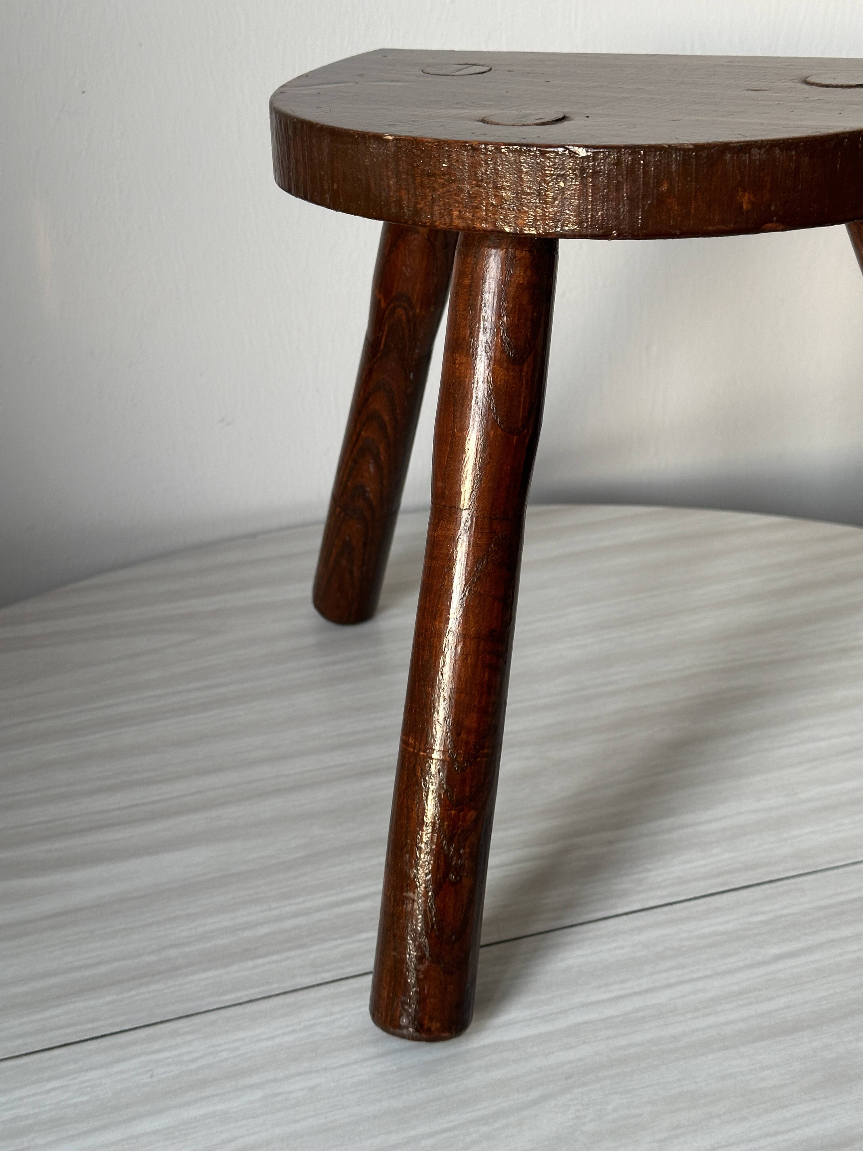 Varnished wooden stool with three legs