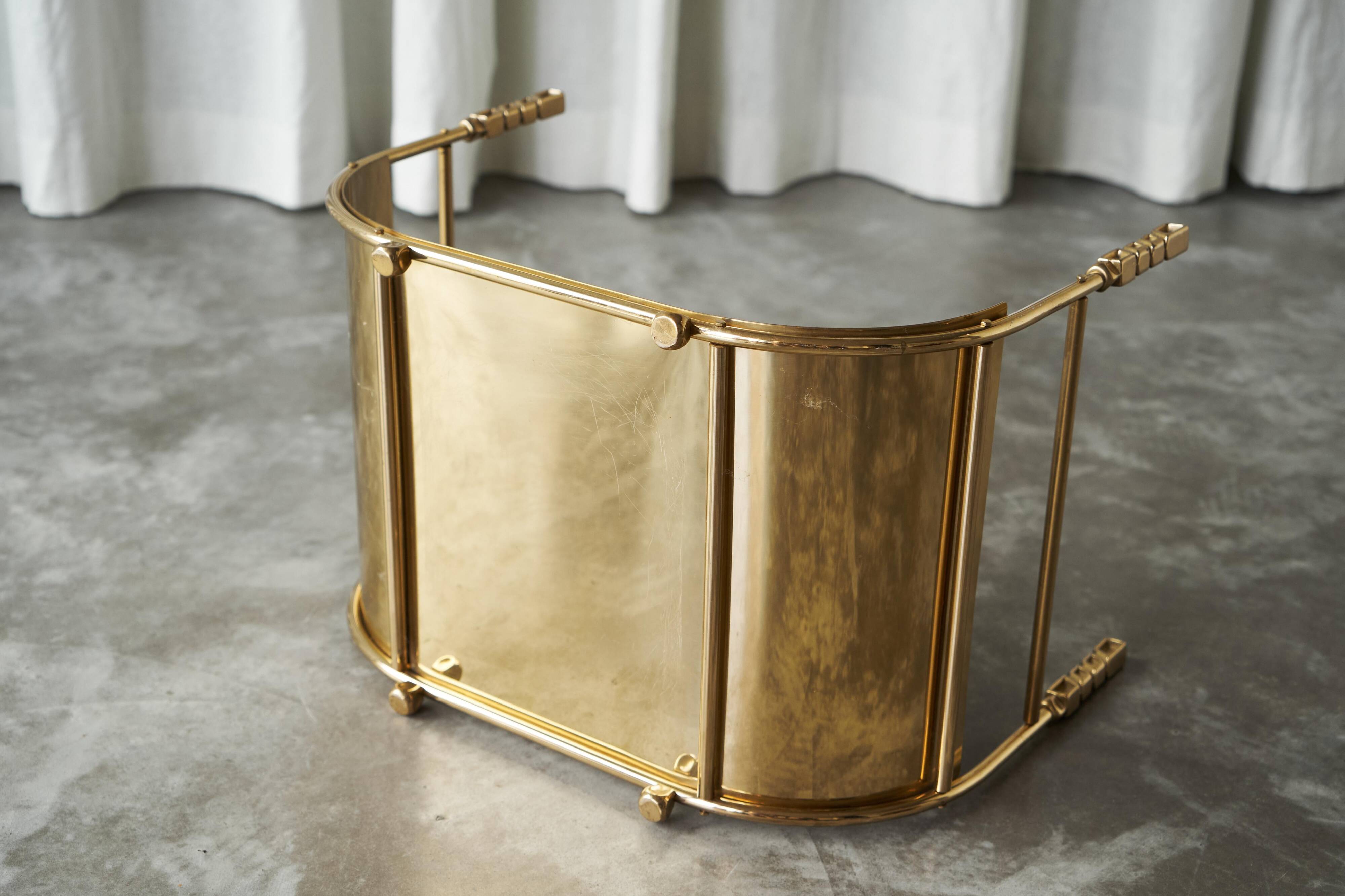 Sculptural brass magazine rack or basket from the 1970s.