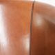 Vintage sheepskin club armchair with a warm colour scheme with black piping