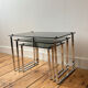 Nest of coffee tables in chrome with smoked glass top.