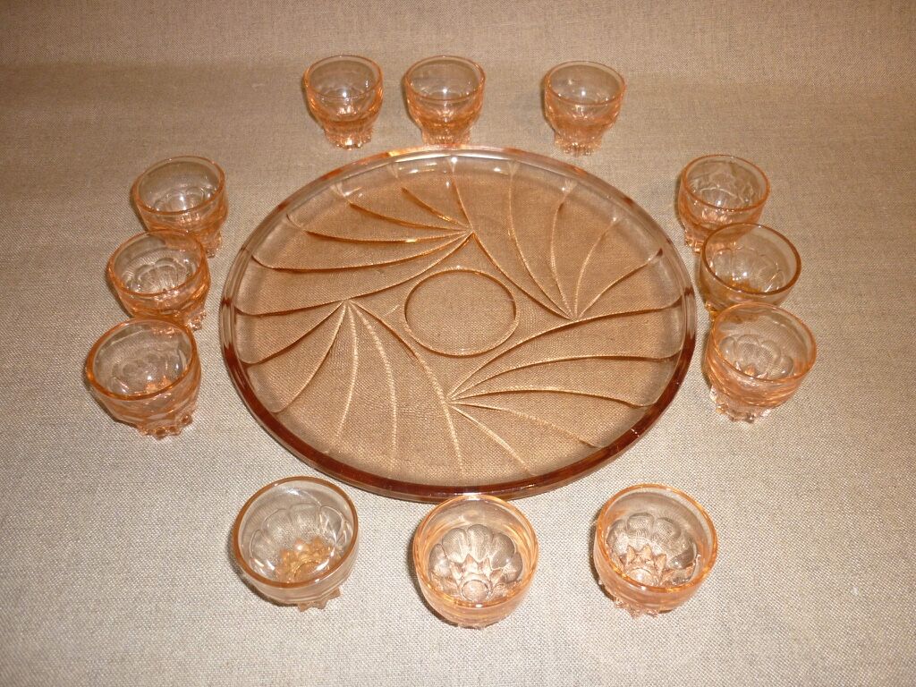 12 shot glasses on pink glass tray