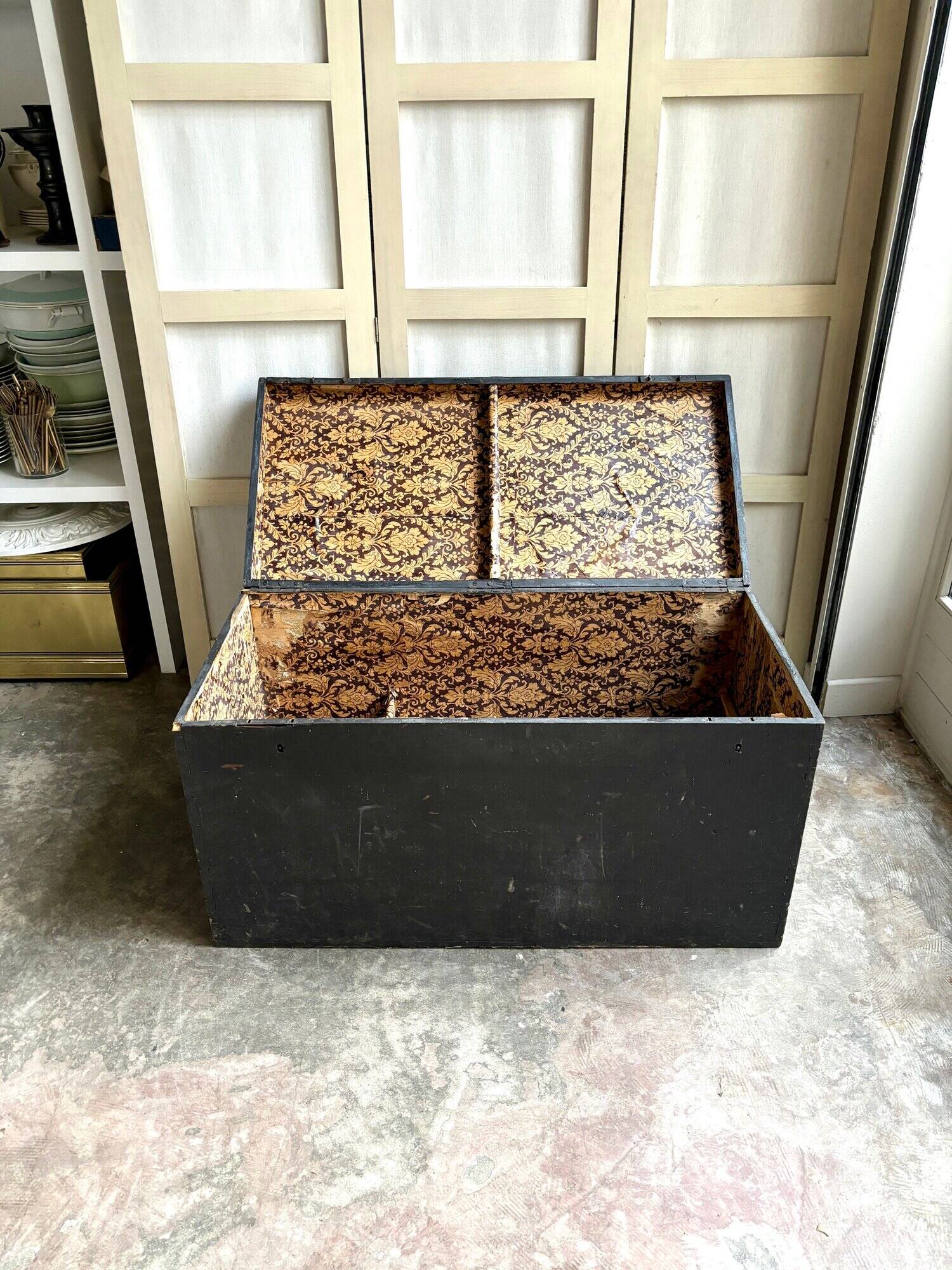 Trunk, black wooden chest and wallpaper