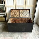 Trunk, black wooden chest and wallpaper