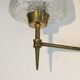 Pair of bronze wall sconces with worked glass reflectors. Stilnovo