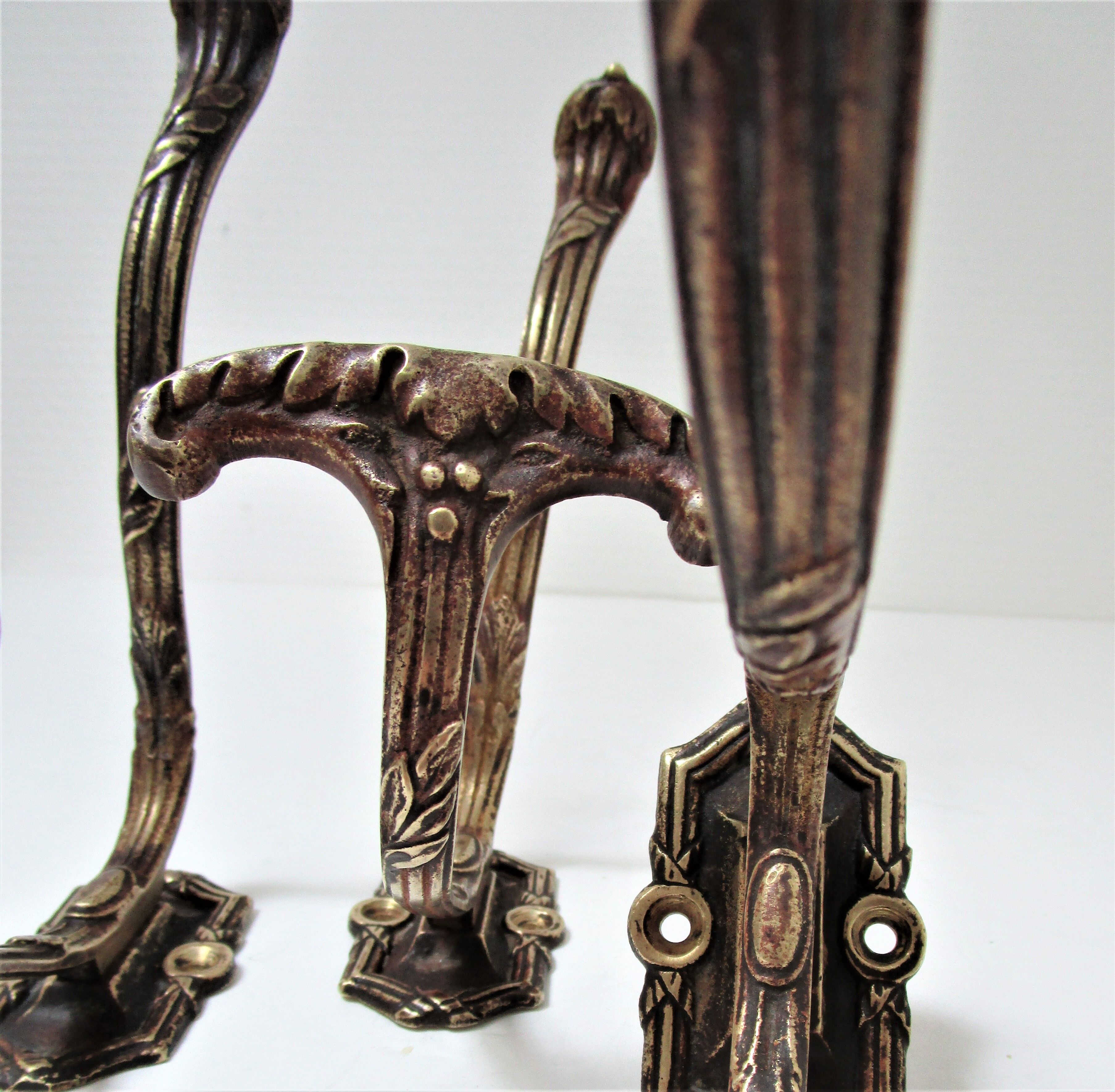Four patères bronze patinated leafy décor early 20th century
