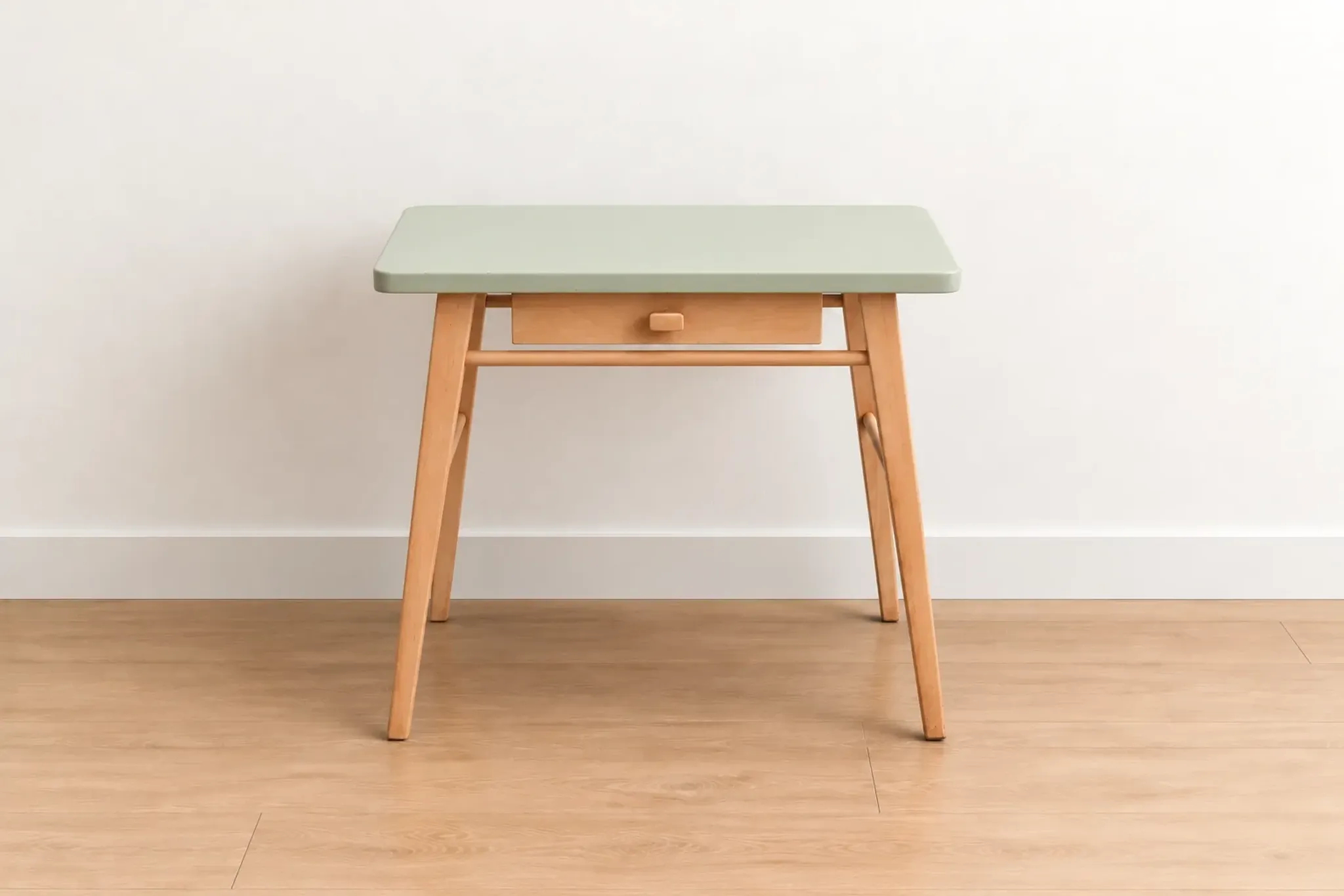 Small vintage children's desk attributed to Baumann – natural wood and lizard green top.