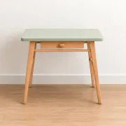 Small vintage children's desk attributed to Baumann – natural wood and lizard green top.