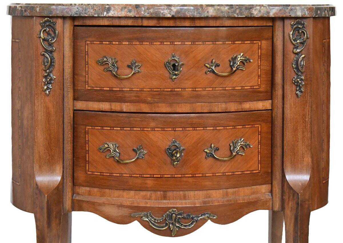 Small kidney-shaped chest of drawers in Transition style.