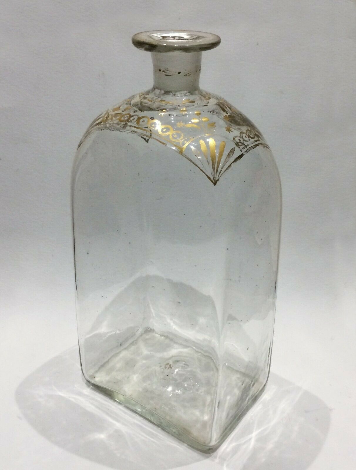 Glass bottle decorated with gold motifs