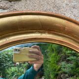 Golden oval mirror