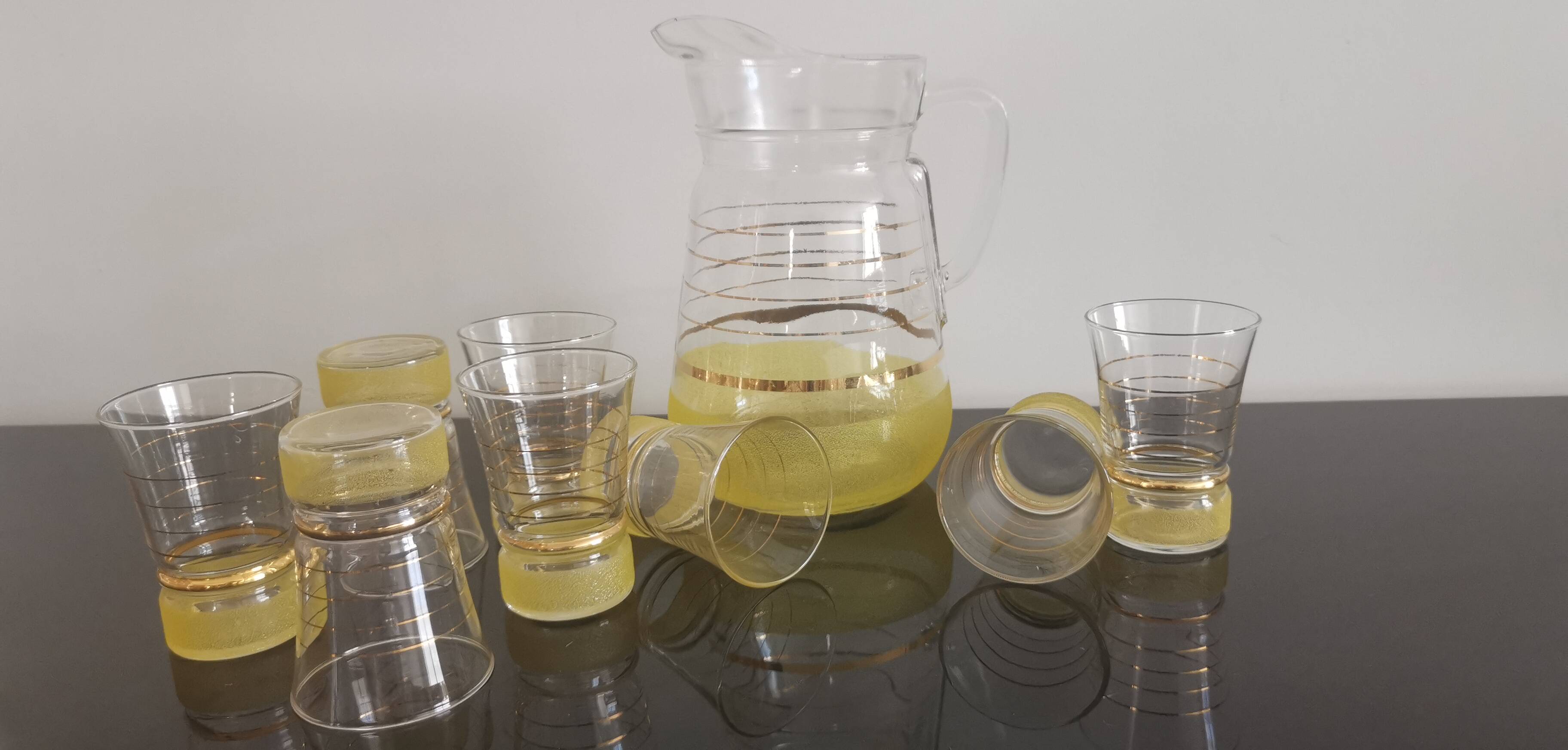 Old pitcher with its 8 yellow granite glasses with gold edging vintage 50's